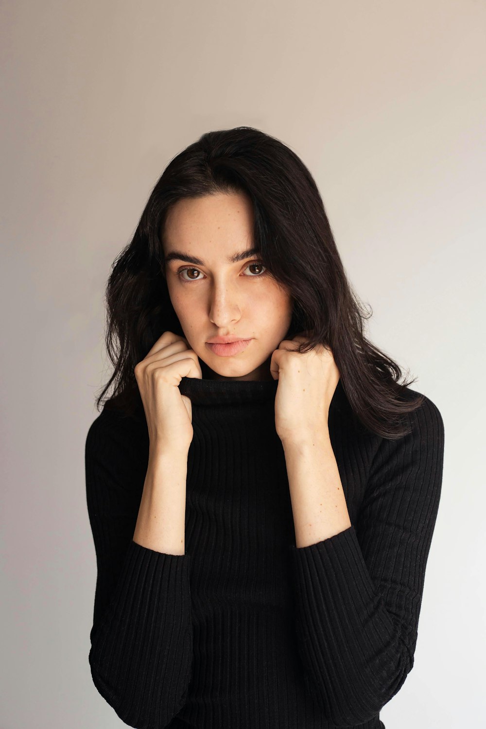 a woman in a black sweater posing for a picture