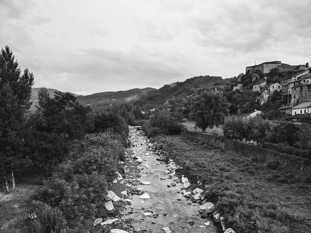 a river running through a lush green hillside