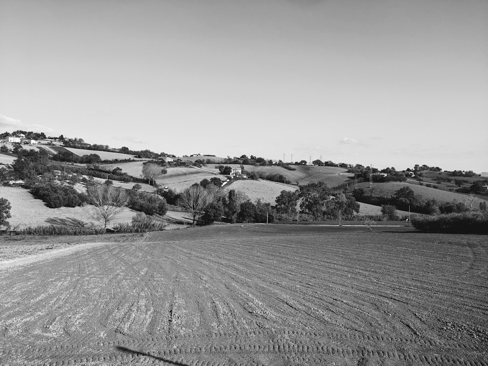 a black and white photo of a plowed field