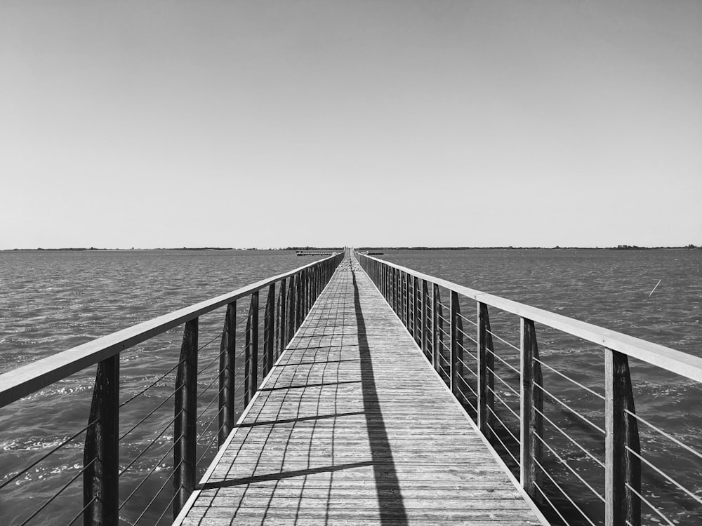 a long pier stretching out into the ocean