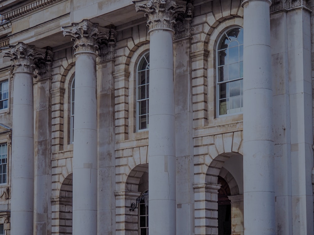 a large building with columns and a clock on the front of it