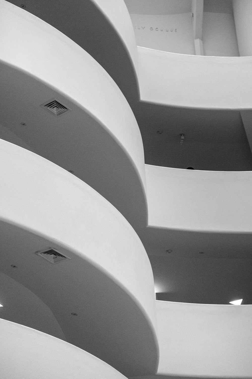 a black and white photo of a curved building