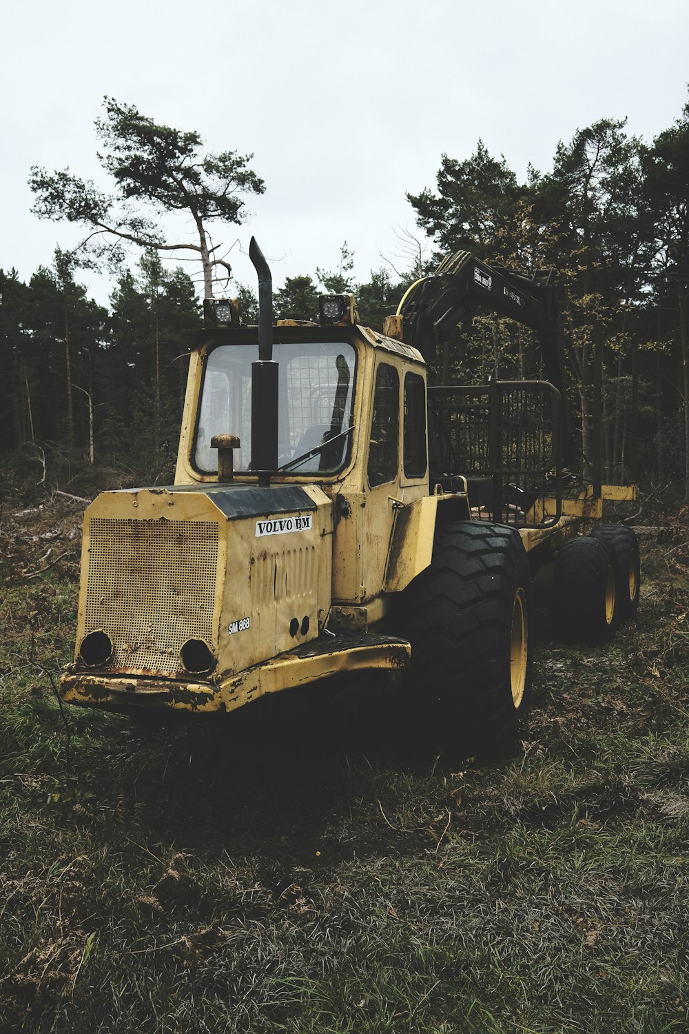 a yellow bulldozer is parked in a field