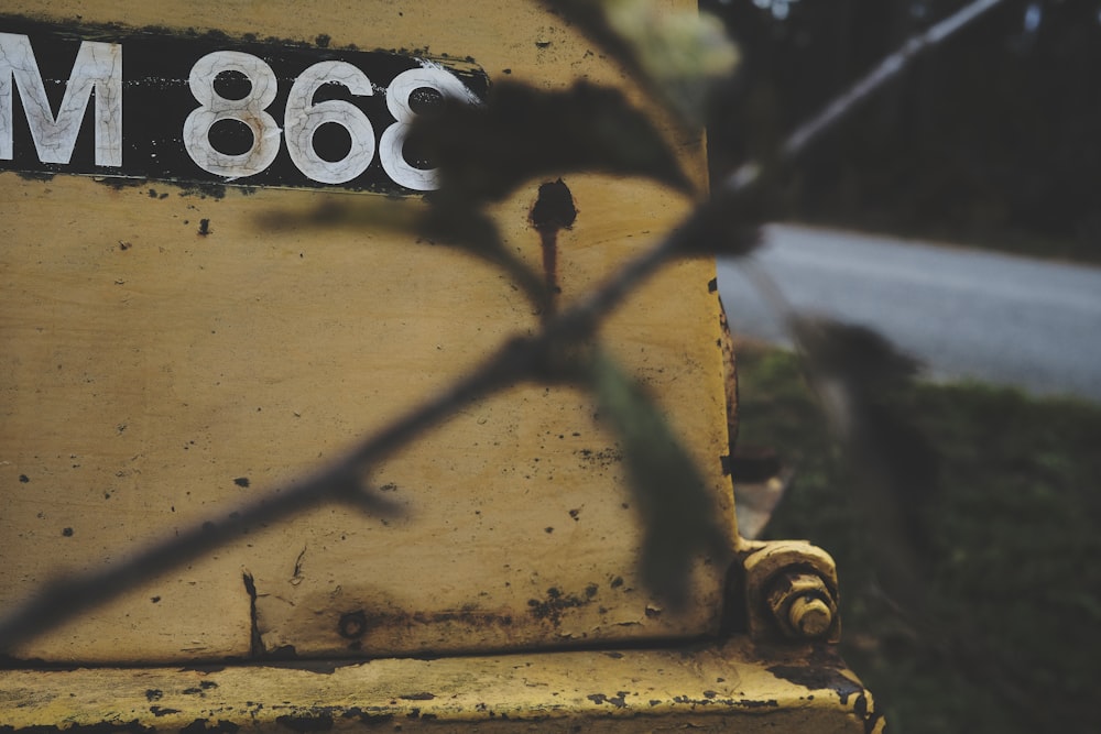 a close up of a yellow bench with a sign on it