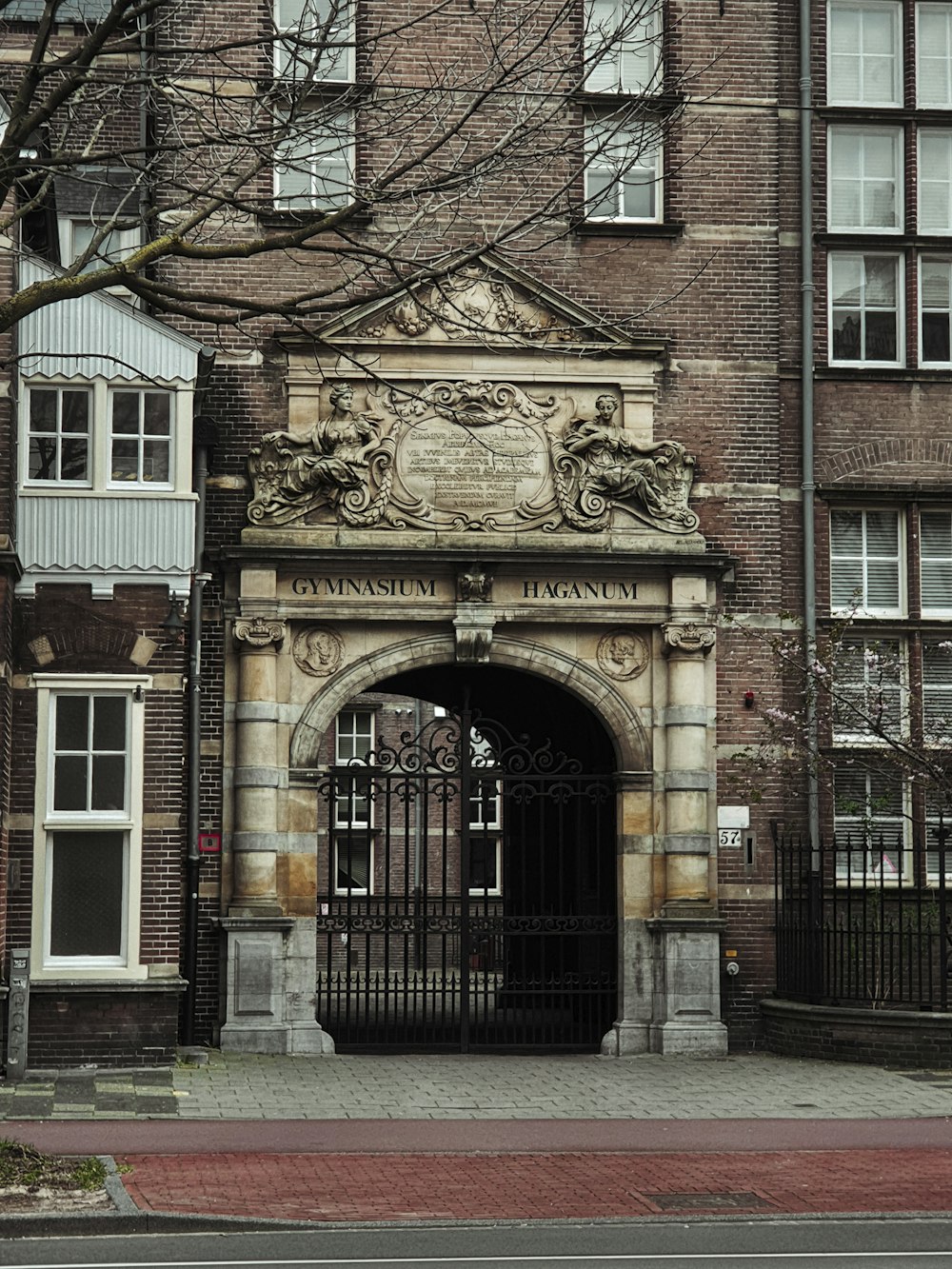 a large brick building with a gate in front of it