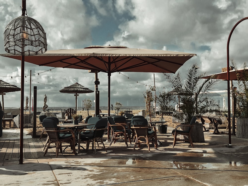 an outdoor dining area with tables and umbrellas