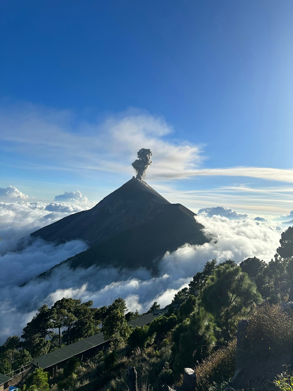 a view of a mountain with a cloud of smoke coming out of the top
