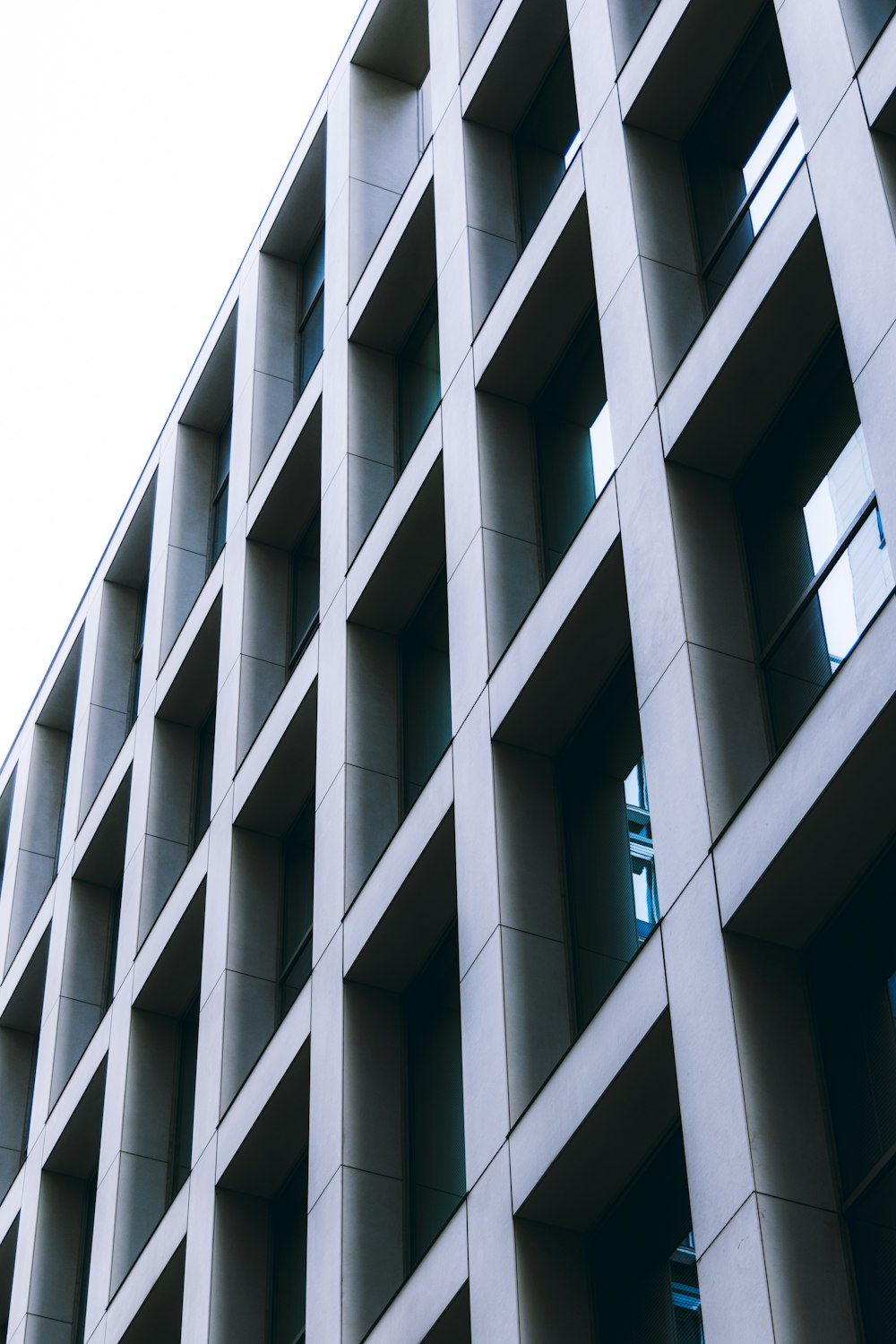 a tall building with lots of windows next to a street