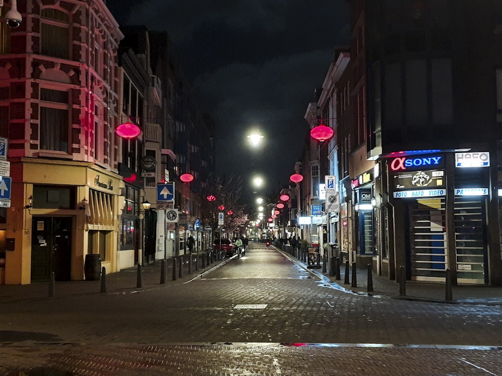 a city street at night with red lights