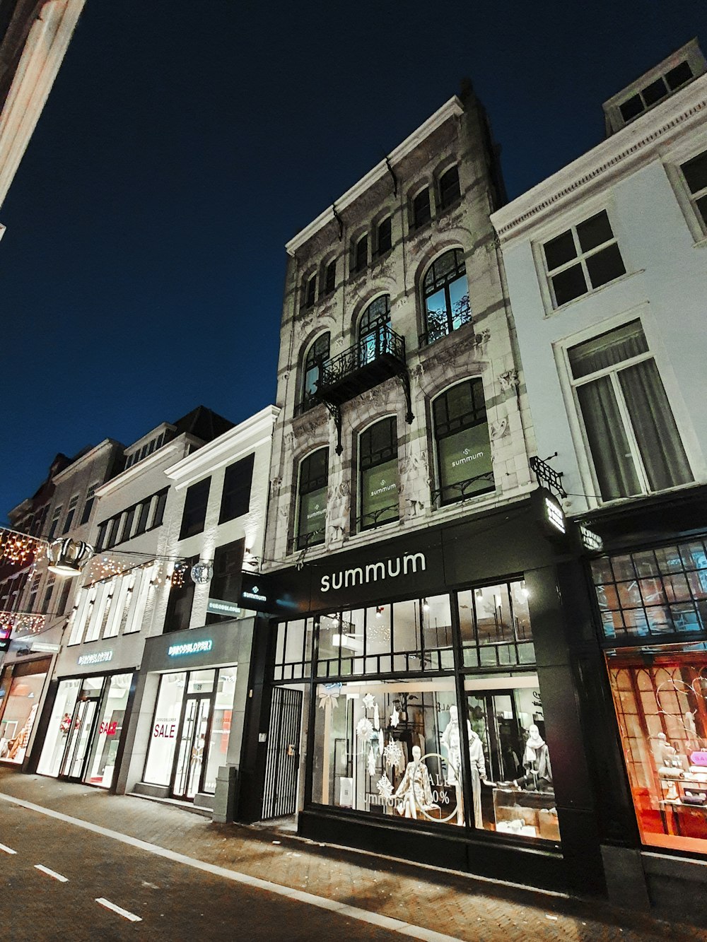 a street corner with a store front at night