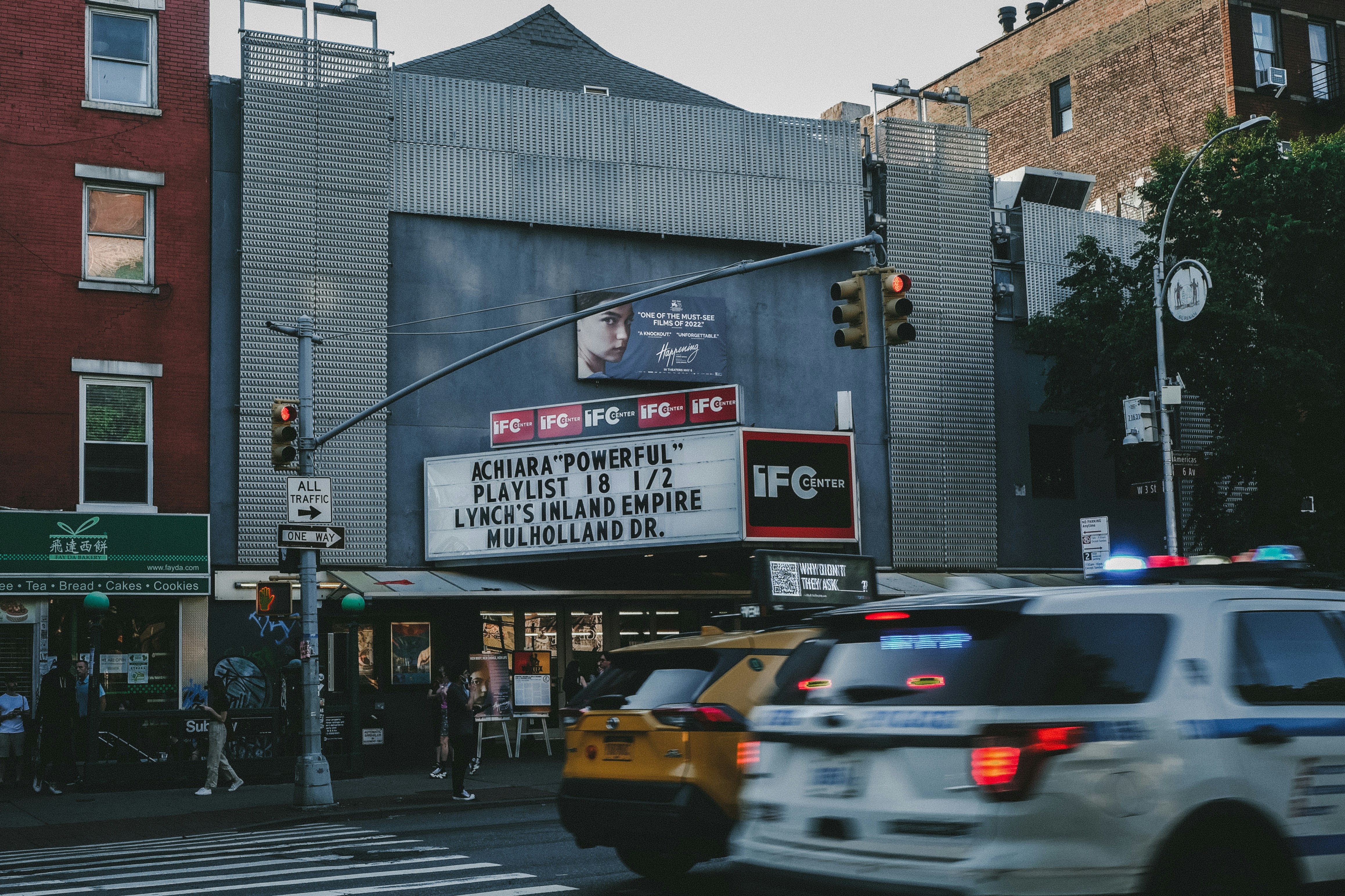 a movie marquee on the corner of a city street