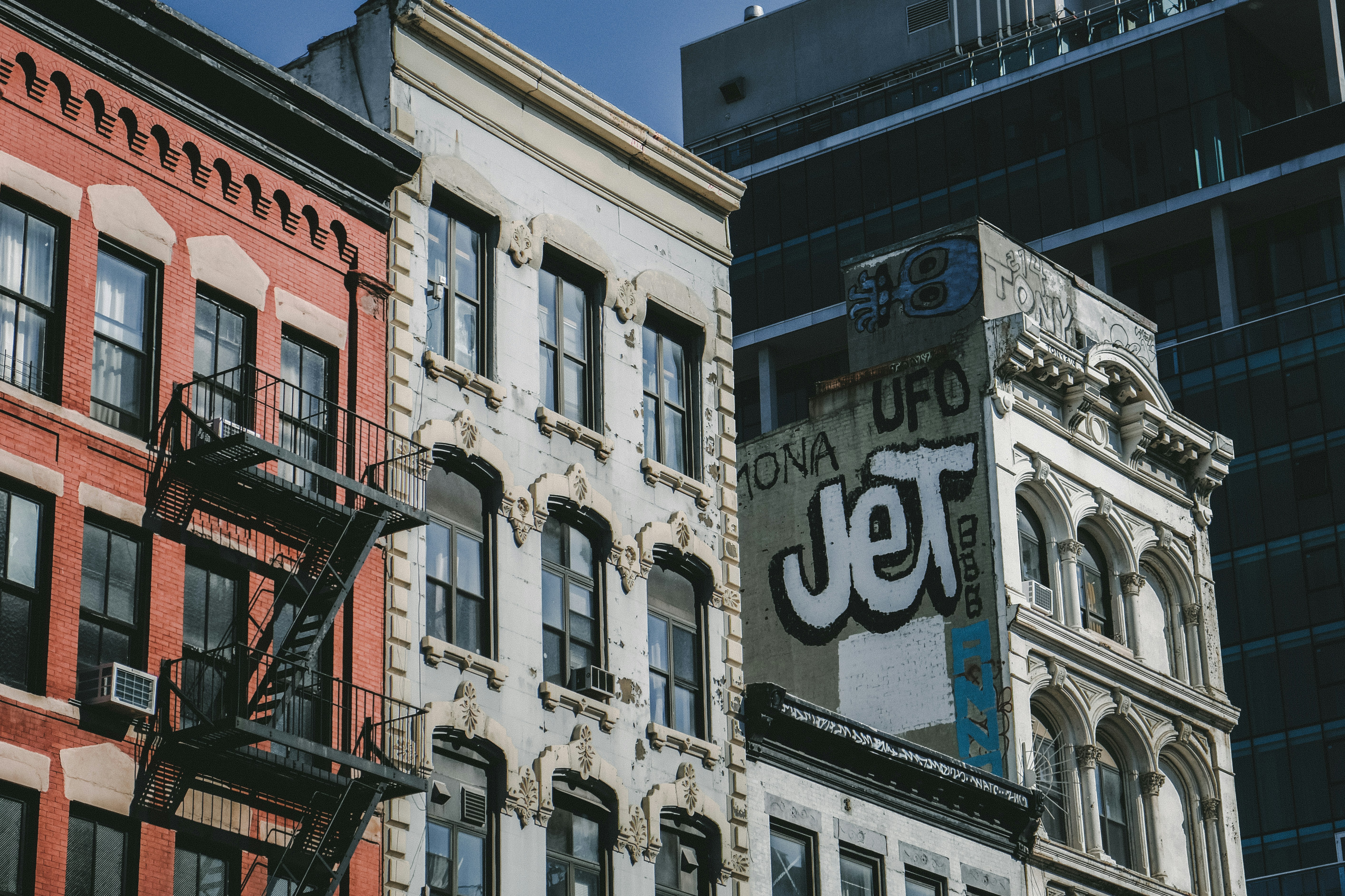 a sign on the side of a building in a city