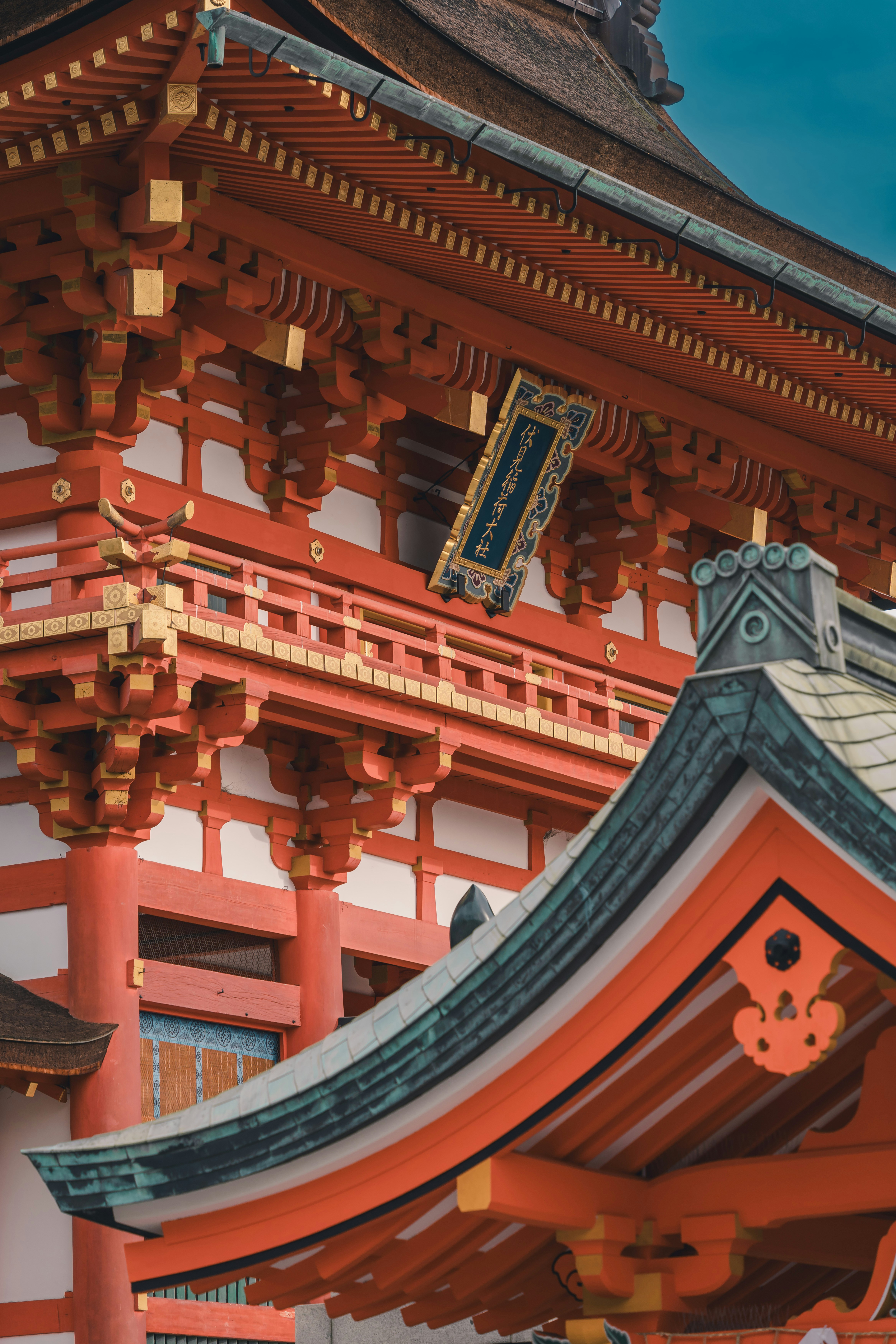 a tall red building with a clock on the top of it