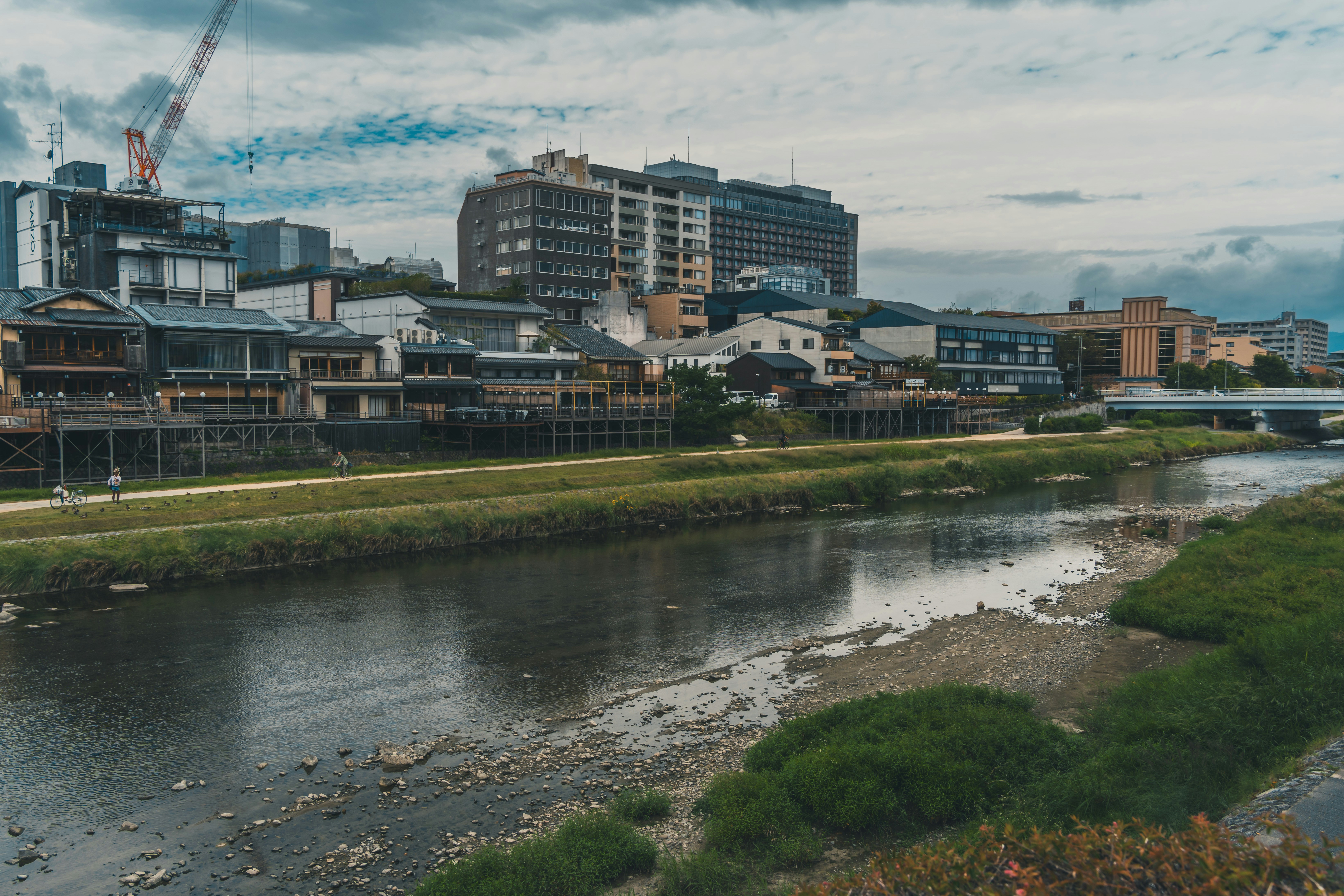 a river running through a city next to tall buildings