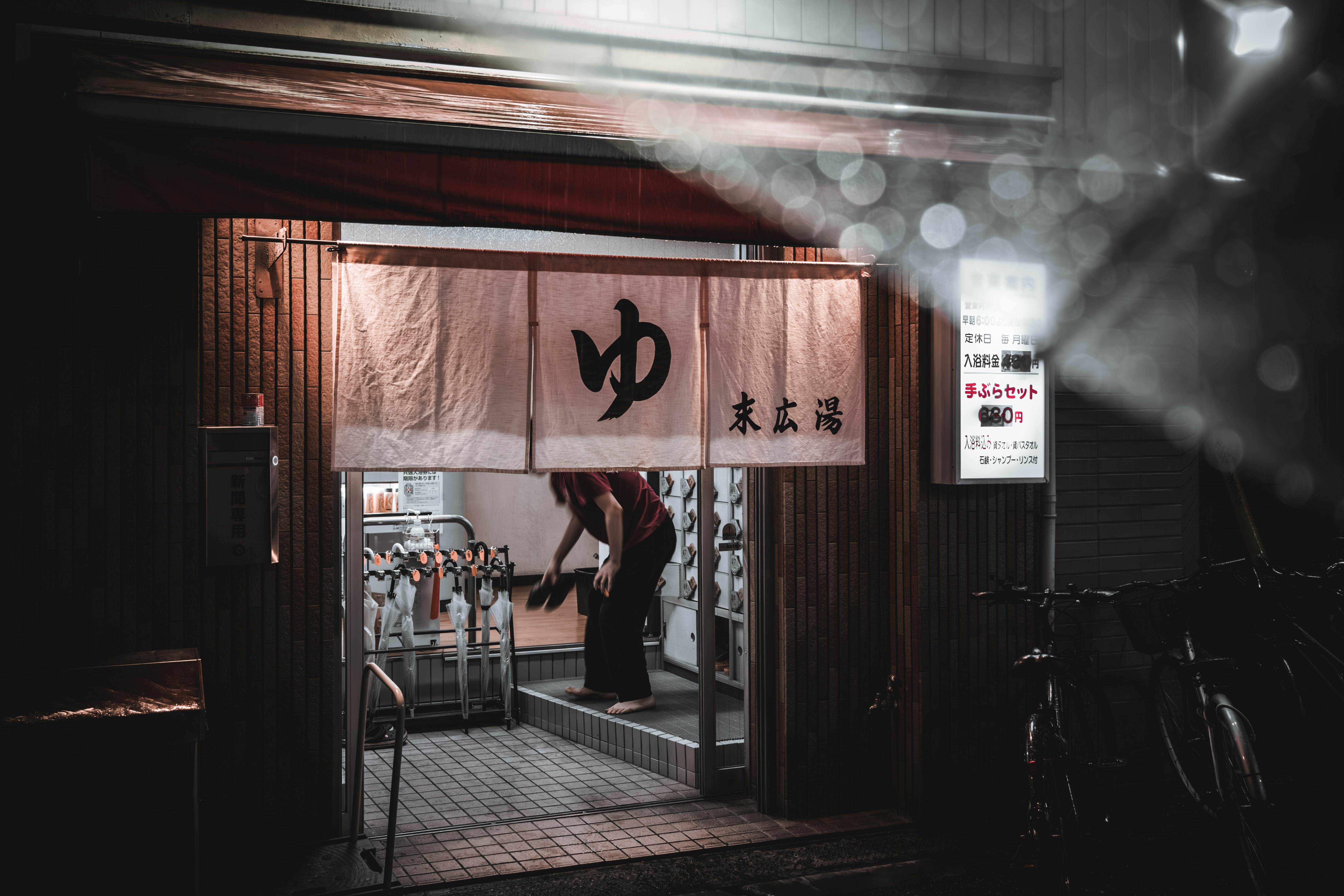 a woman standing in a doorway of a restaurant