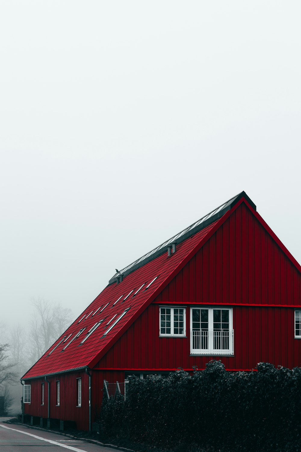 a red barn with a red roof and a white window