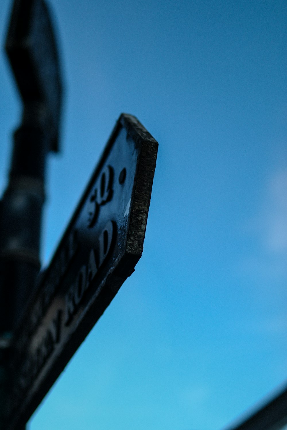 a close up of a street sign with a sky background