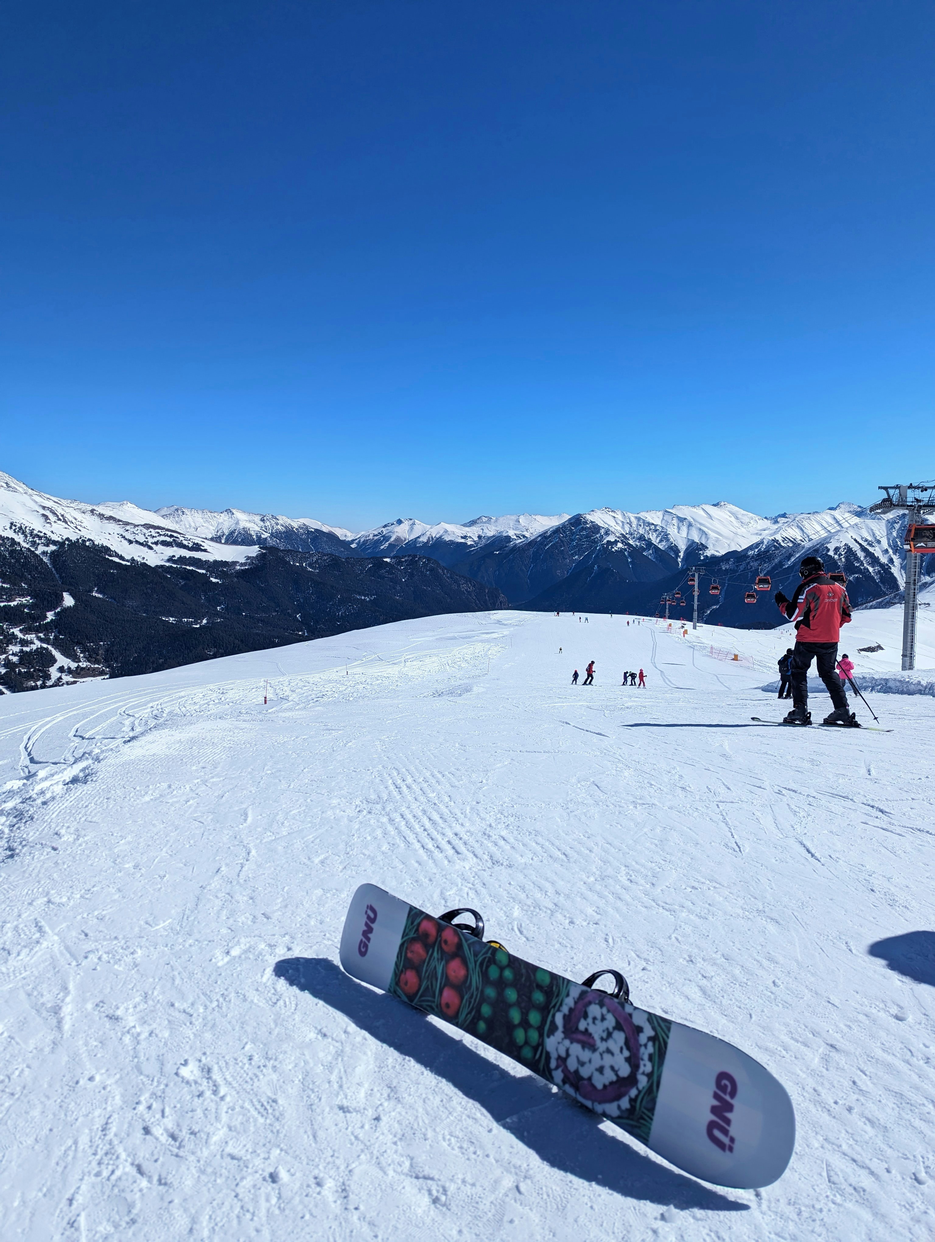 a snowboard sitting on top of a snow covered slope