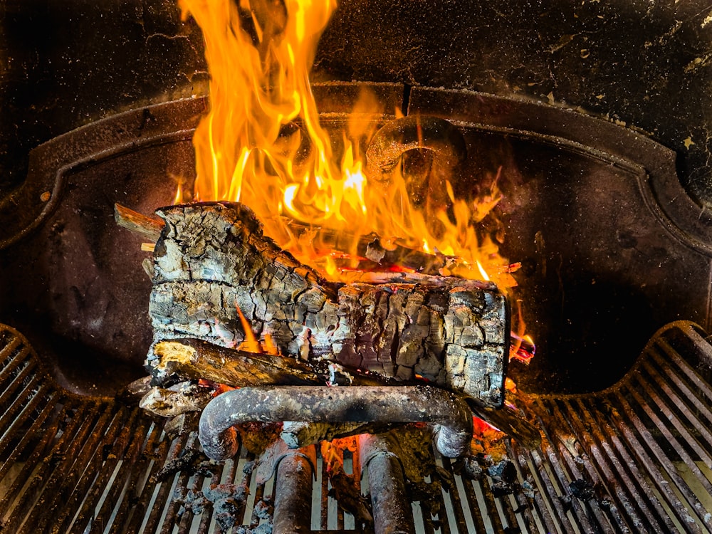 a close up of a grill with a fire in it