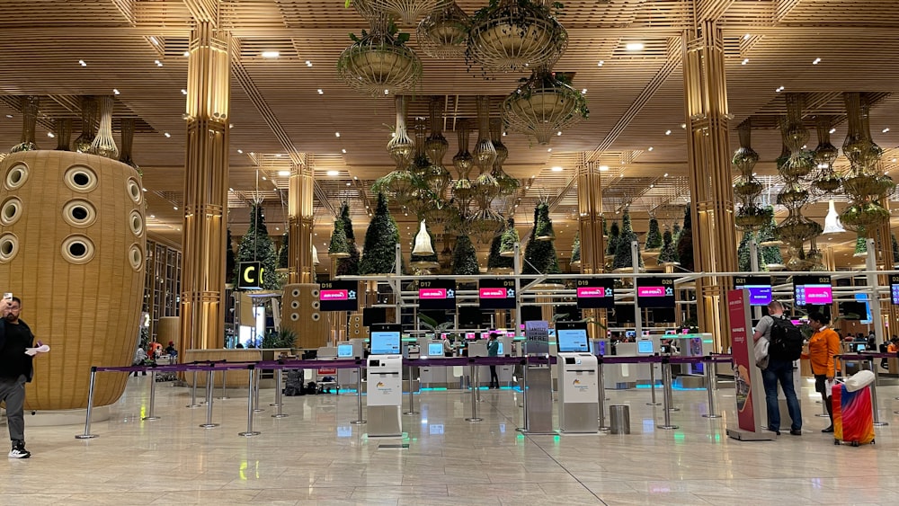 a group of people standing around a luggage carousel