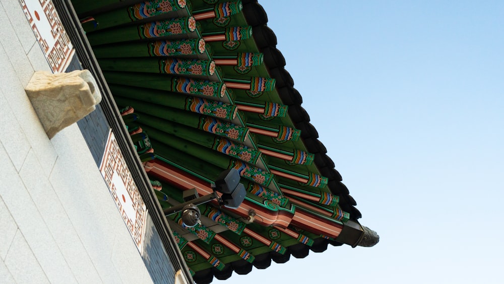a close up of a roof with a sky in the background