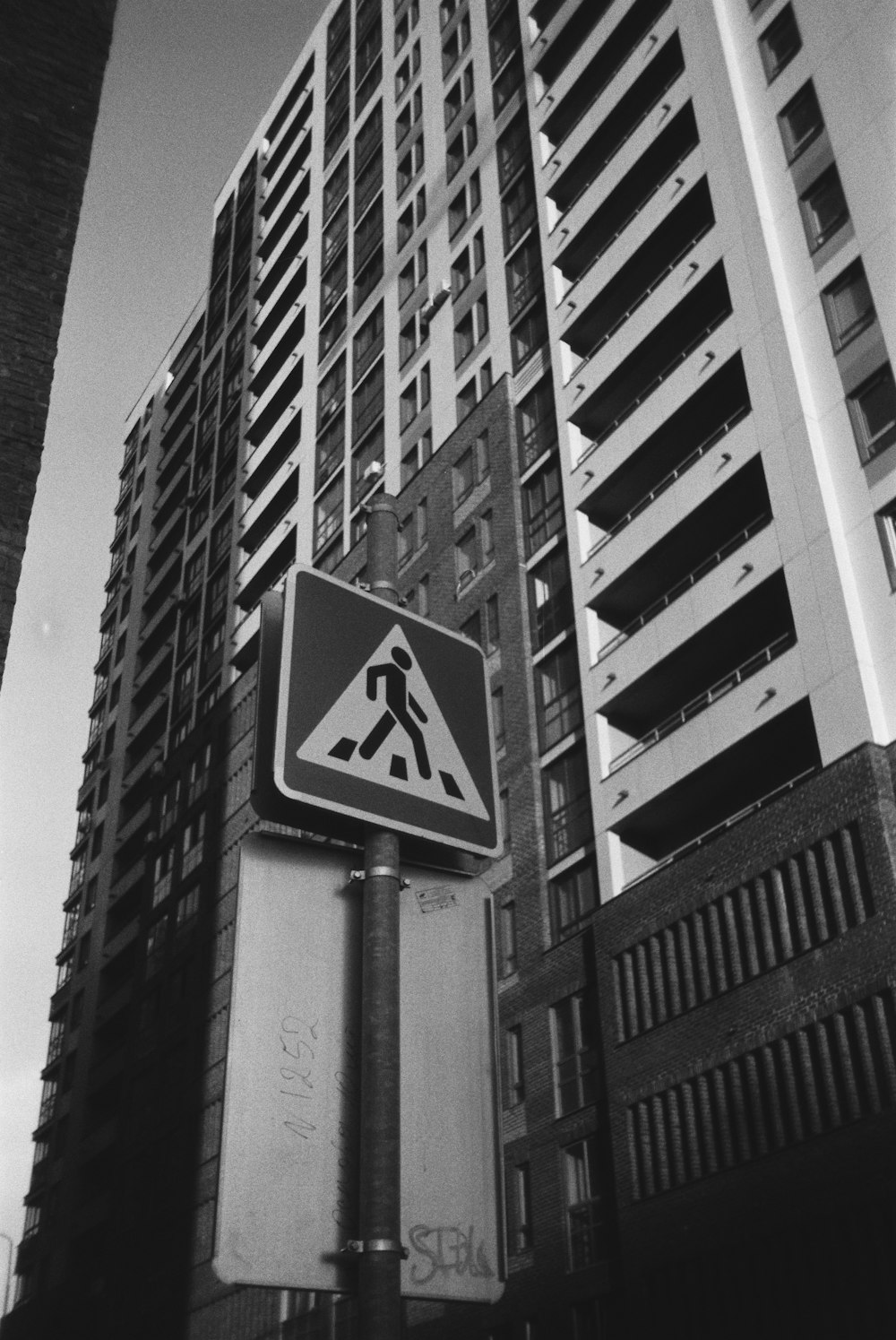 a street sign in front of a tall building