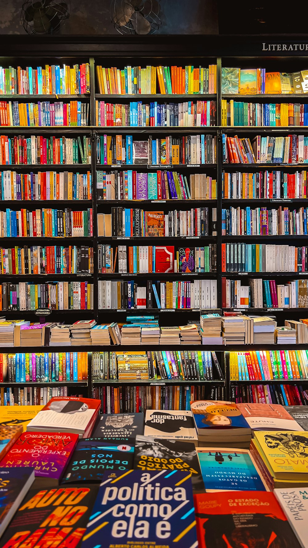 a bookshelf filled with lots of colorful books