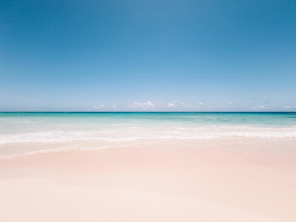 a sandy beach with a clear blue sky