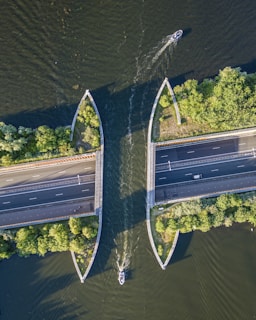 an aerial view of two boats on a river