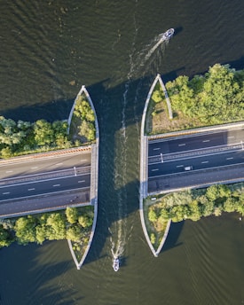 an aerial view of two boats on a river