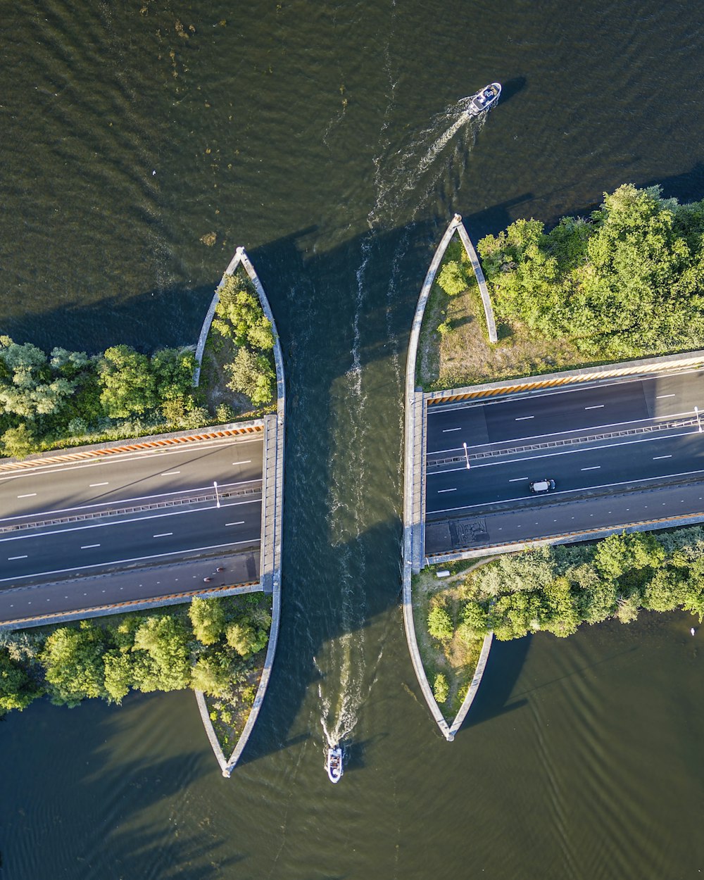 an aerial view of two boats on a river