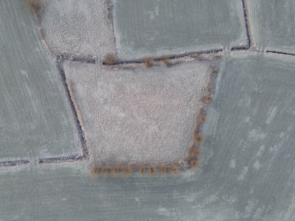 an aerial view of a snow covered field