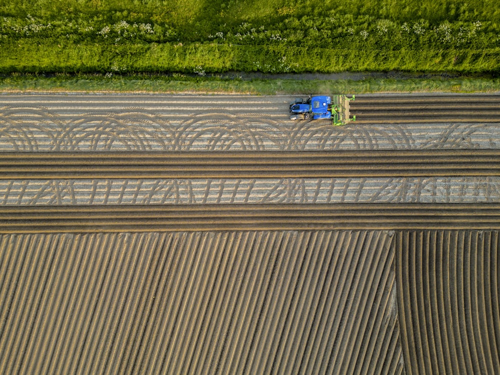 an aerial view of a tractor plowing a field