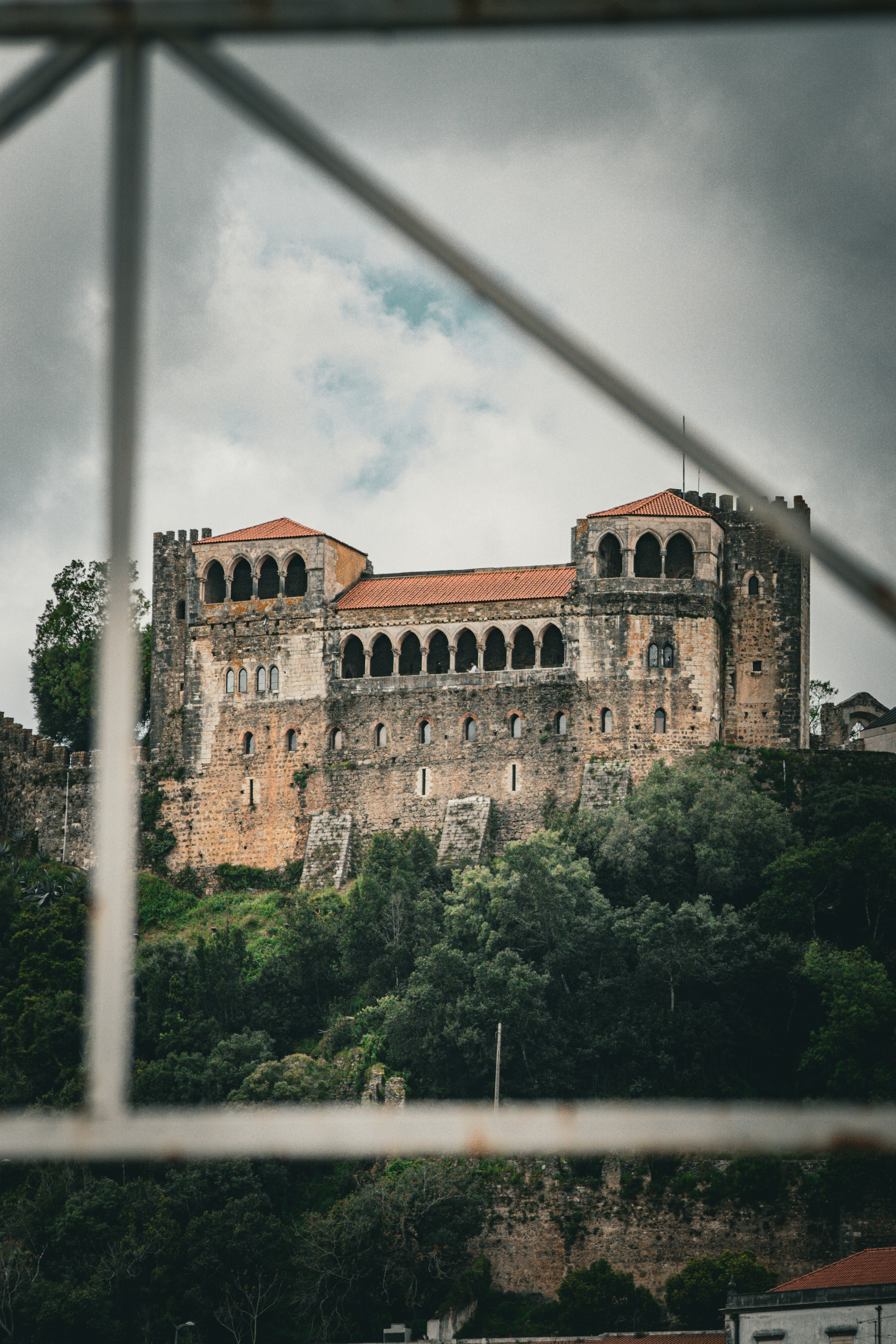 a castle on top of a hill surrounded by trees