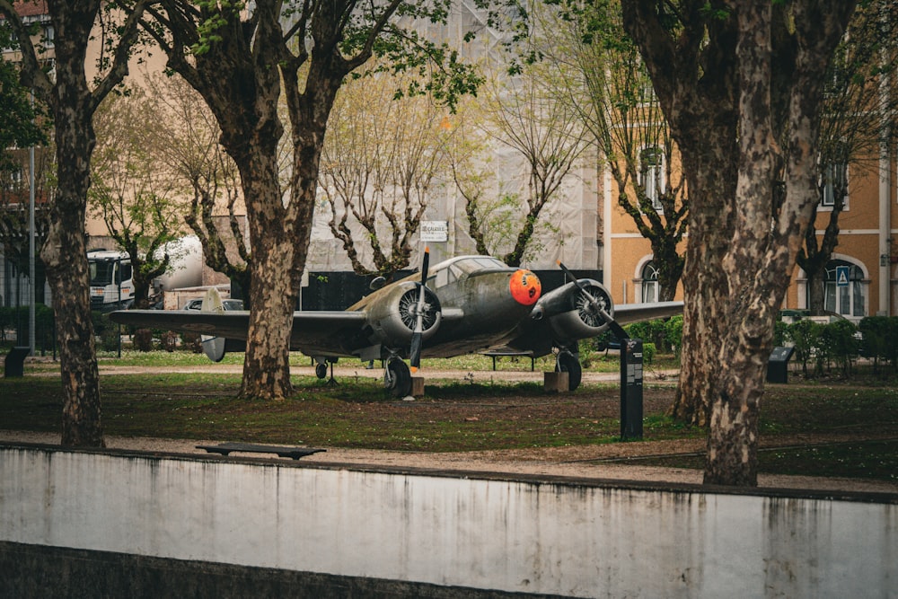 a small plane is parked in a park