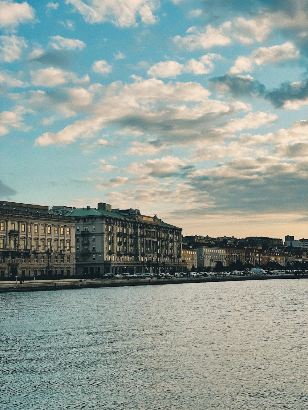 a large body of water with buildings in the background