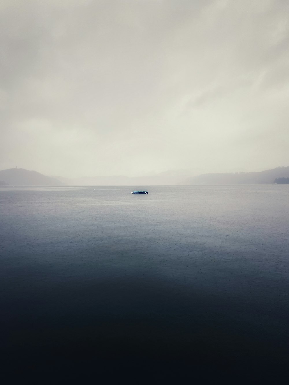 a large body of water sitting under a cloudy sky