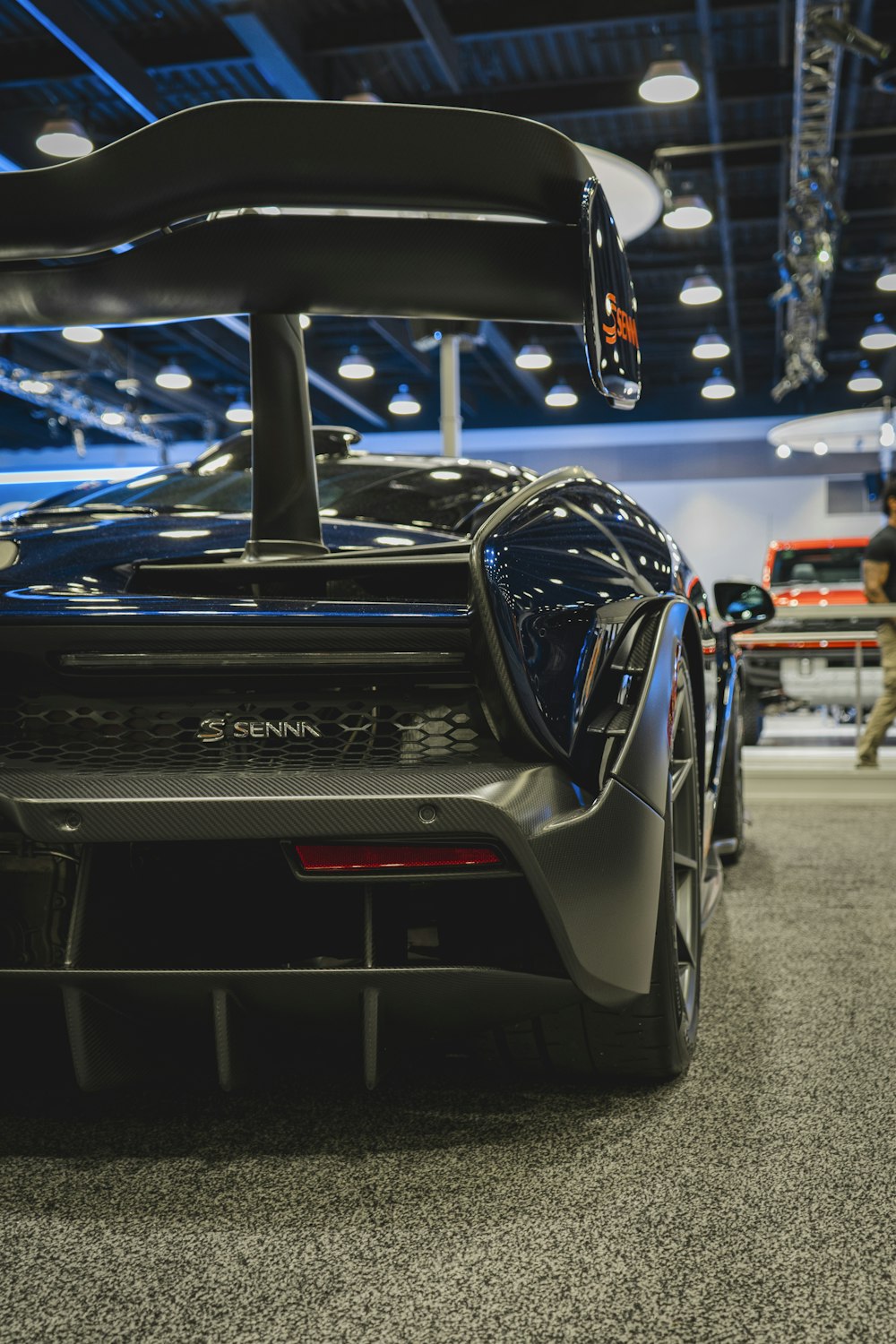 a black sports car parked inside of a building