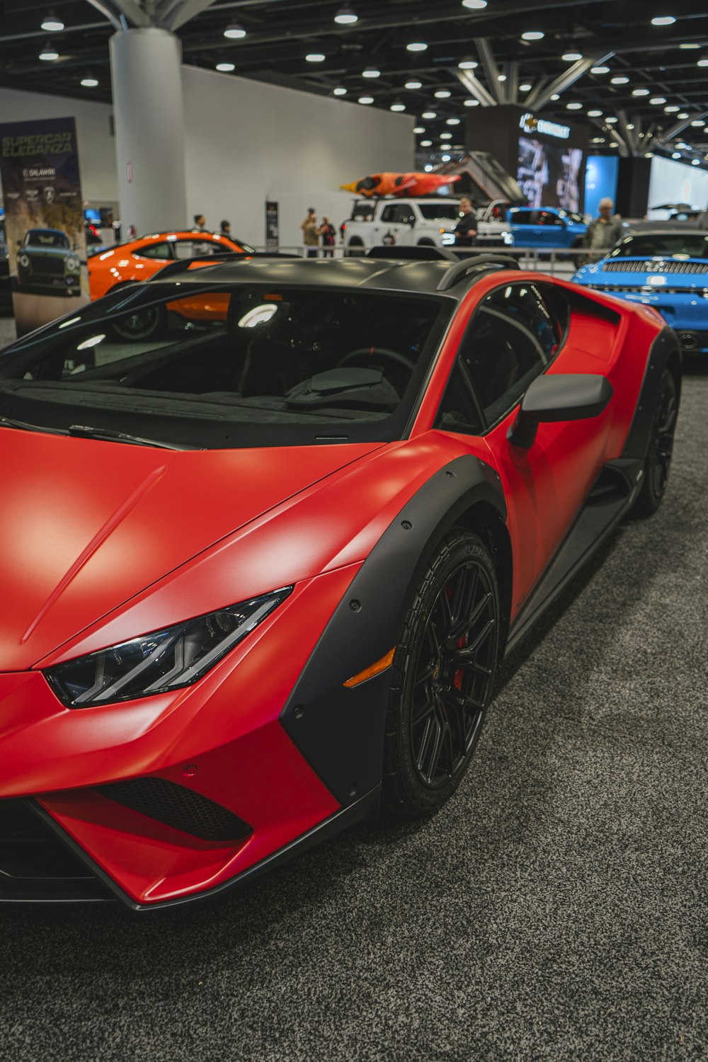 a red sports car parked in a showroom