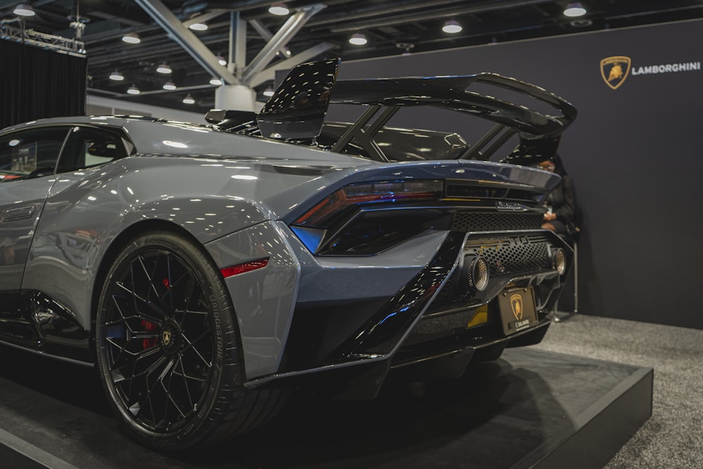 a silver sports car on display at a car show