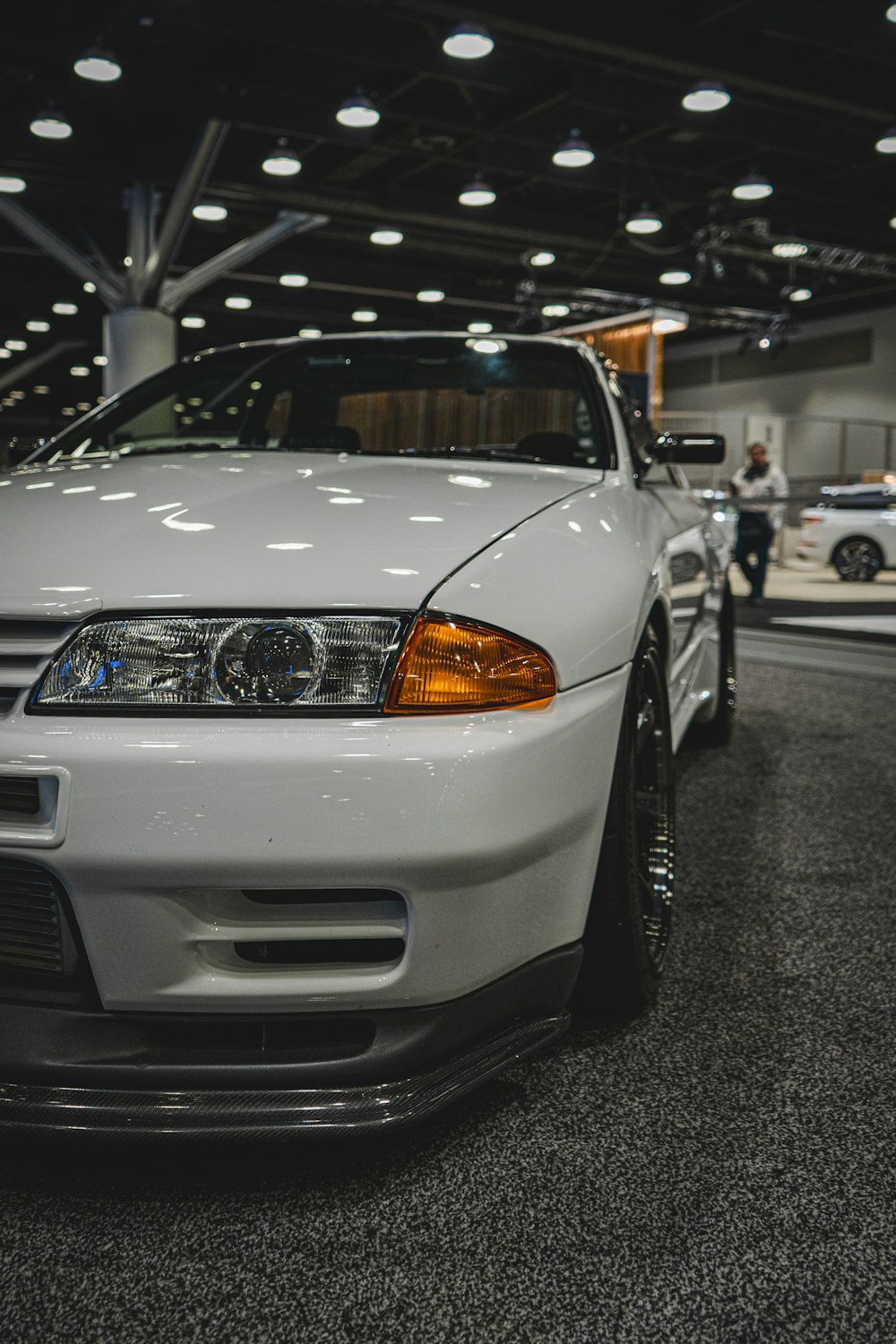 a white car parked inside of a garage