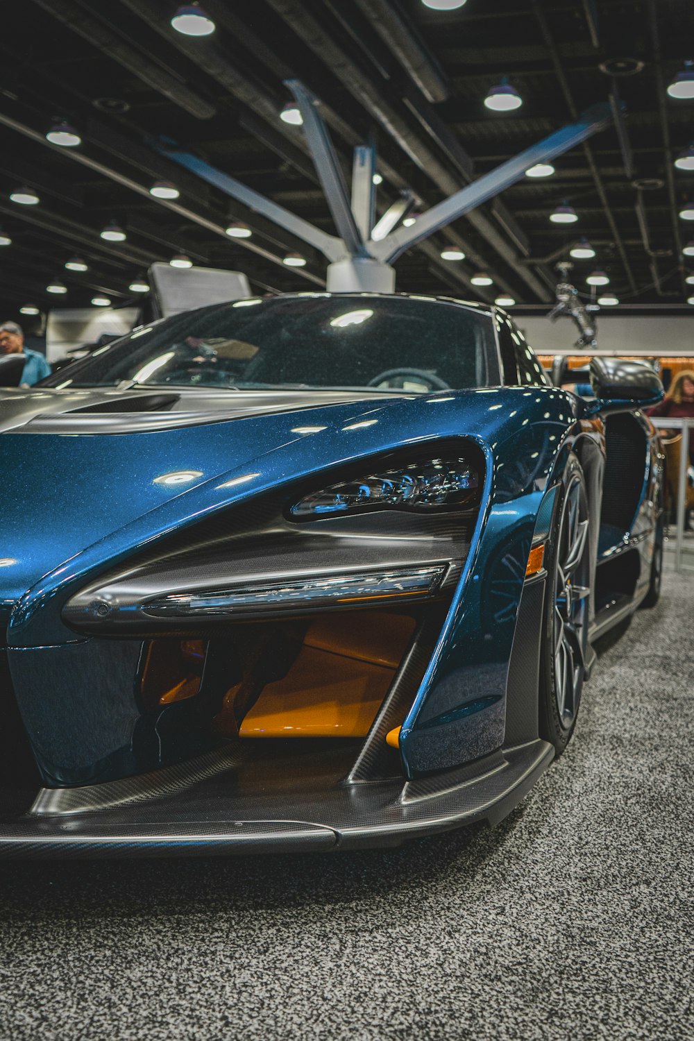 a blue sports car parked inside of a building