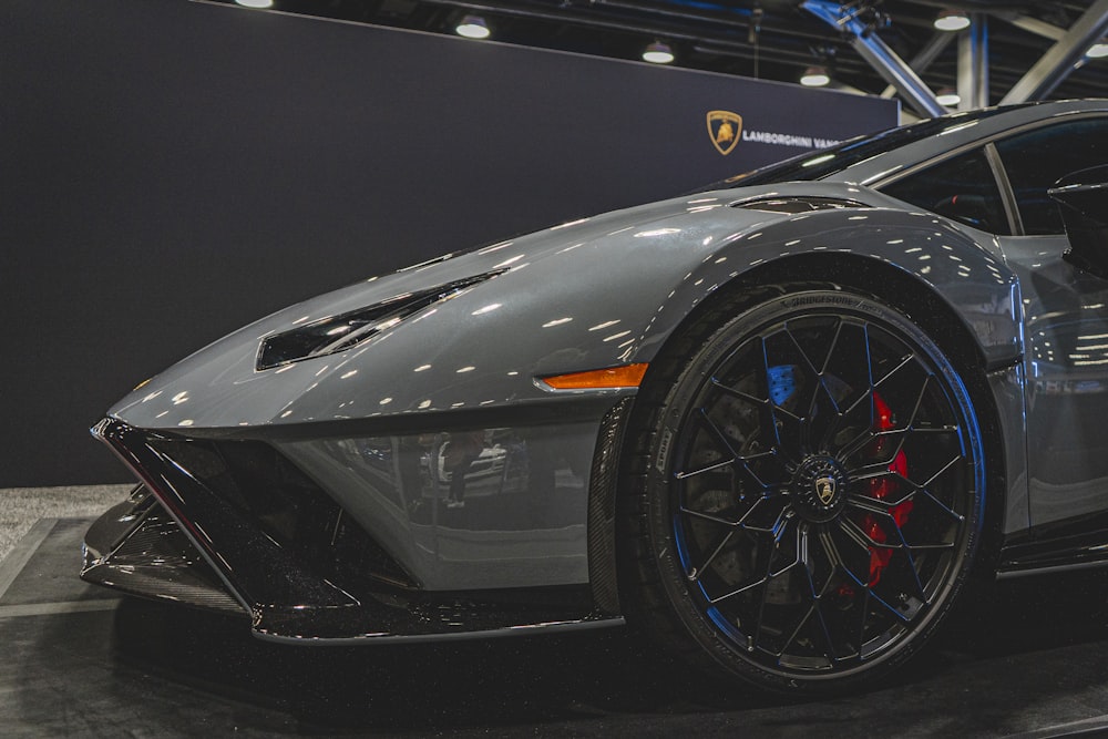 a grey sports car on display at a car show