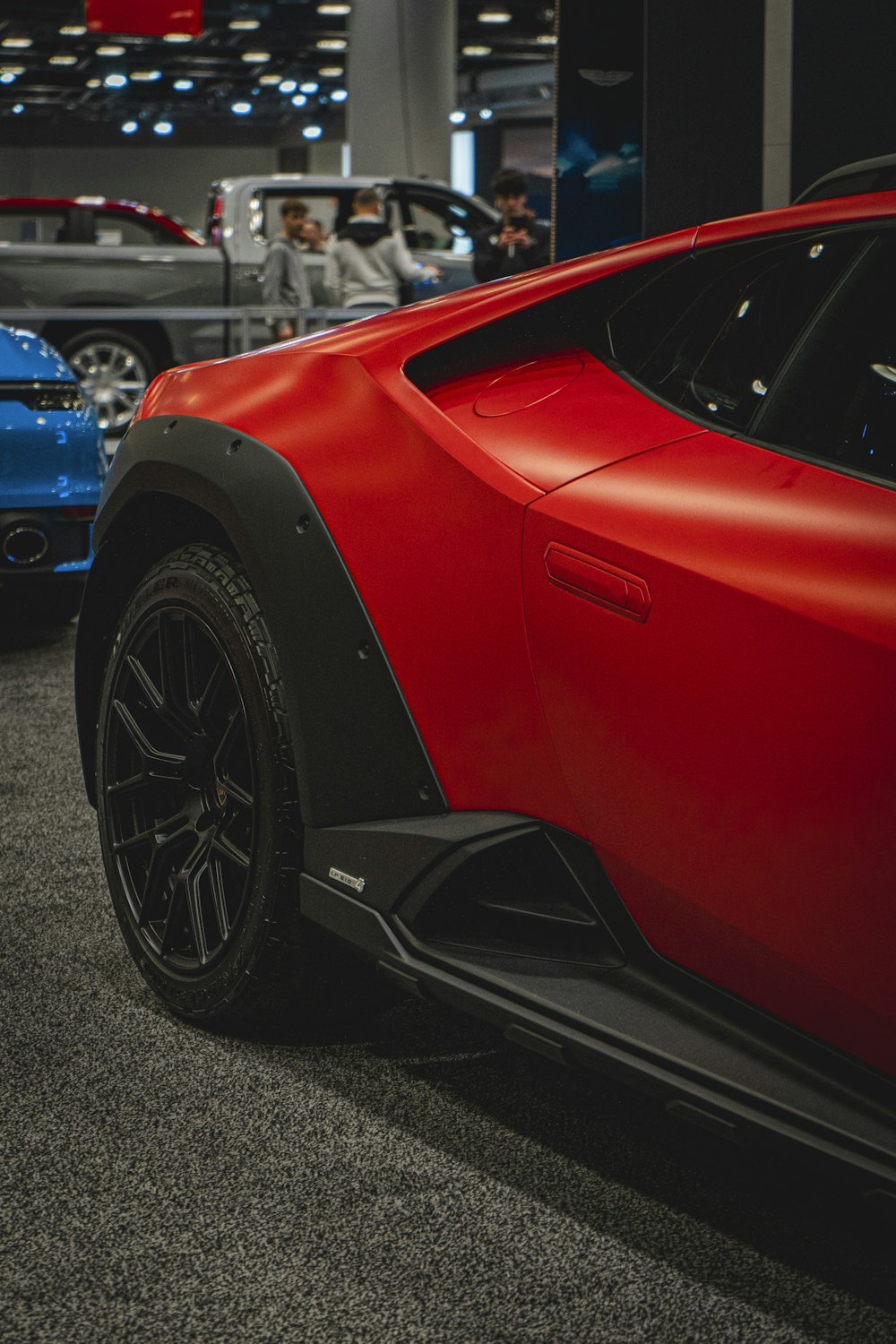 a close up of a red sports car on display