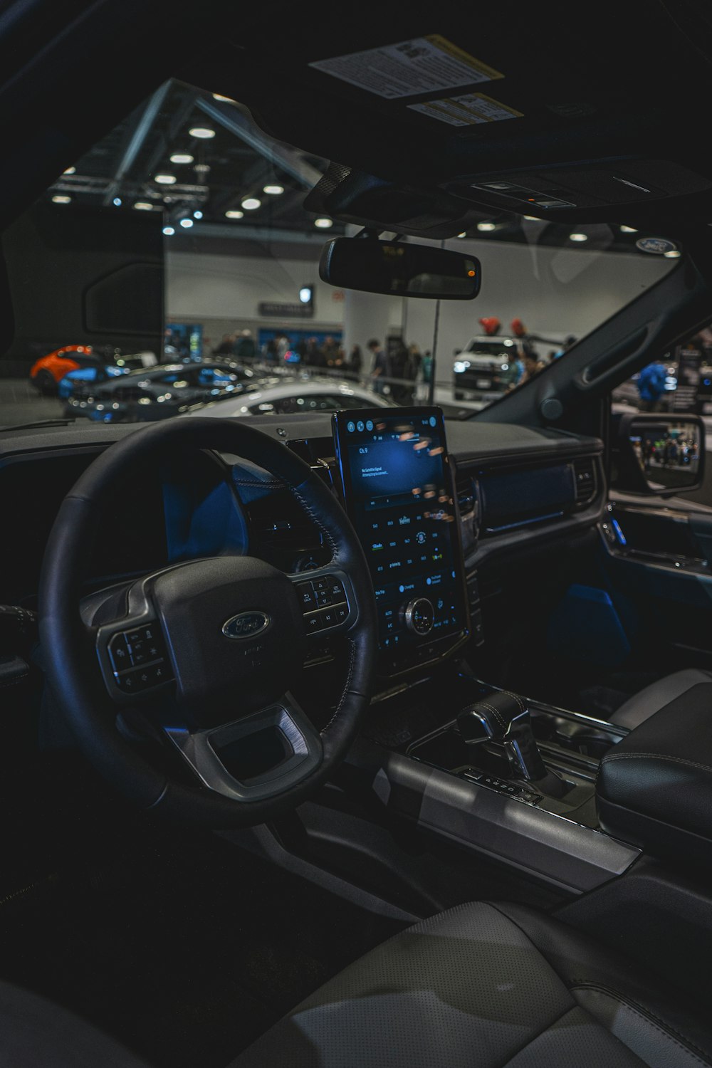 the interior of a car with a lot of people in the background