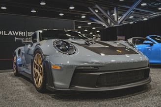a grey sports car on display at a car show