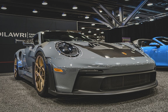 a grey sports car on display at a car show