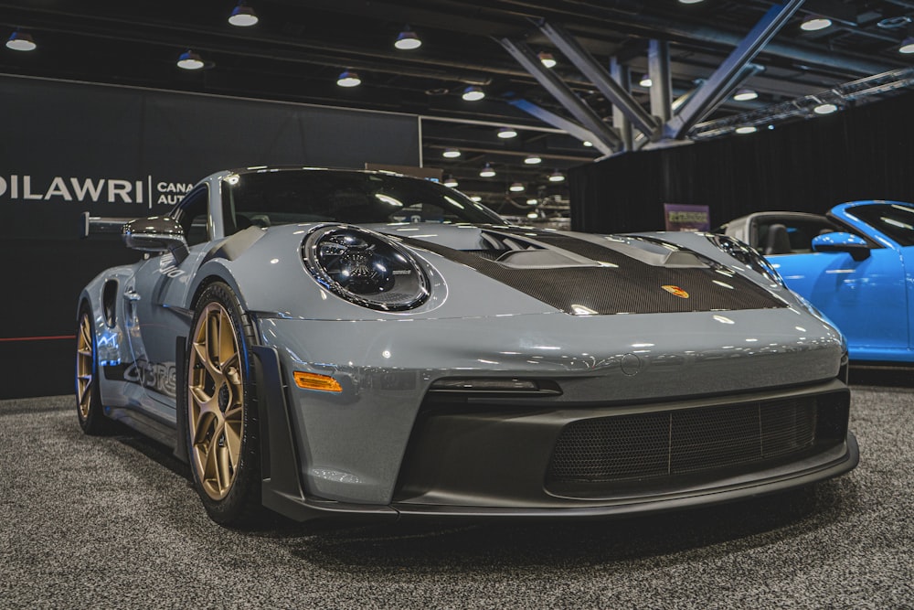 a grey sports car on display at a car show