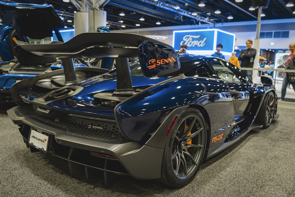 a blue sports car on display at a car show