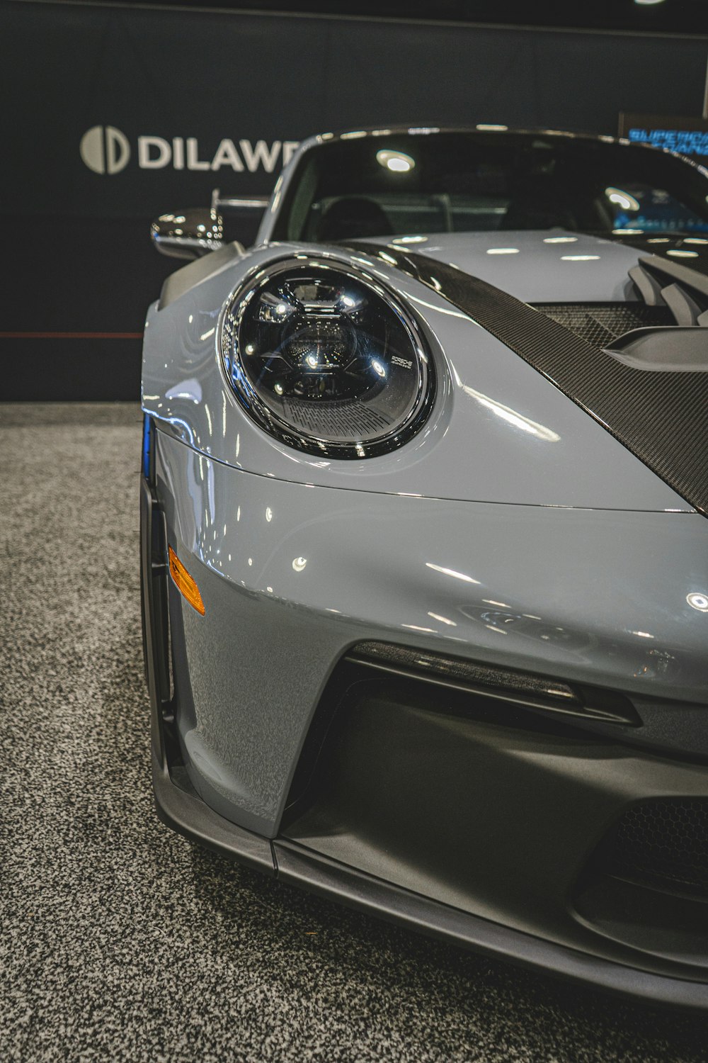 a grey sports car parked in a showroom